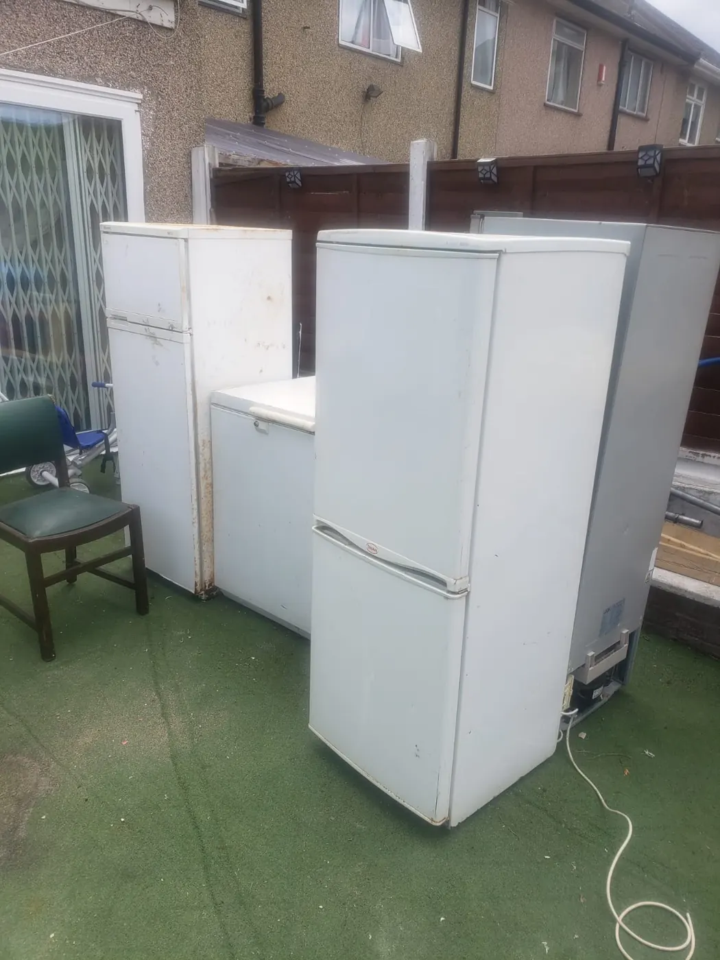 Old fridges and freezers in a garden waiting for WasteMove to remove them