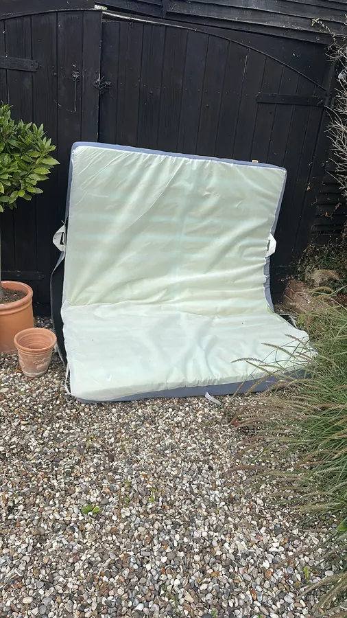 Before: an old mattress left by a garden gate