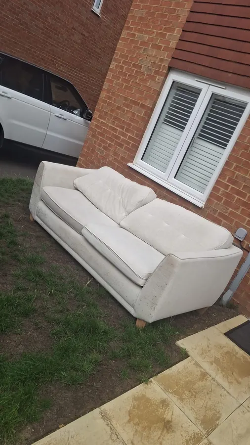 Before: an old sofa left on a front lawn