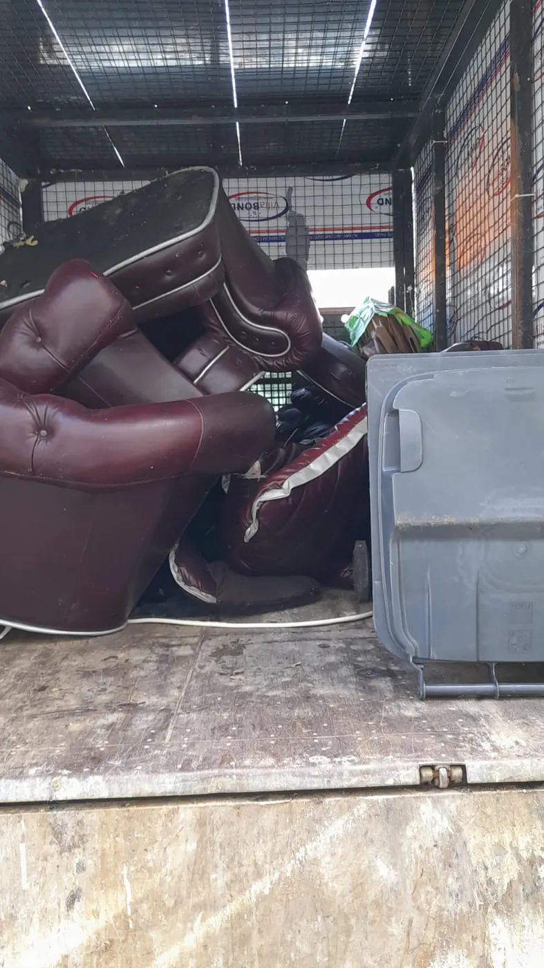 Old leather sofas loaded into a WasteMove van